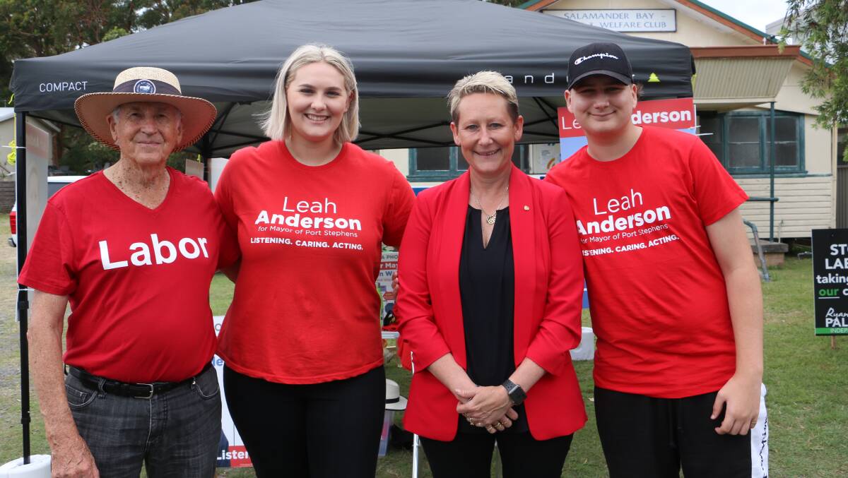Mayoral candidate Leah Anderson in Salamander Bay on Saturday with supporter Graham Froment and her two children, Mackenzie Goring and Hunter Goring.
