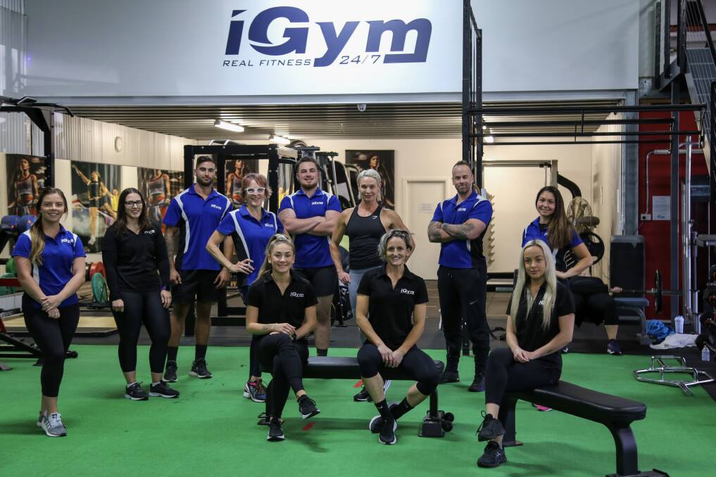 UPBEAT: iGym Salamander Bay club manager Carly Taylor, sitting centre, with her team. Instructors found new ways to reach members during the gym's closure in the lockdown period. Picture: Ellie-Marie Watts