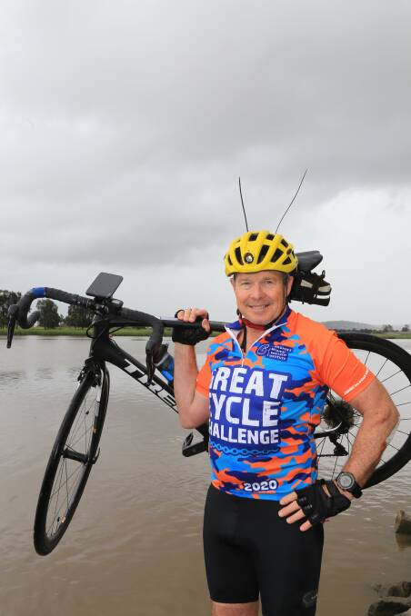 Dr Justin Smith by the Hunter River at Raymond Terrace. He is undertaking the Great Cycle Ride this October for a third year.