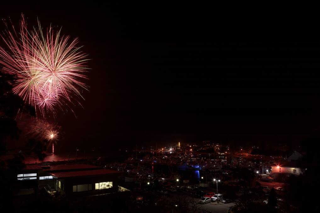 BANG: The New Year's Eve fireworks spectacular over Nelson Bay on Tuesday. Image shows the fireworks, set off from a barge on the water, above Nelson Bay's marina and shops along Trevally Street. Picture: Stephen Keating