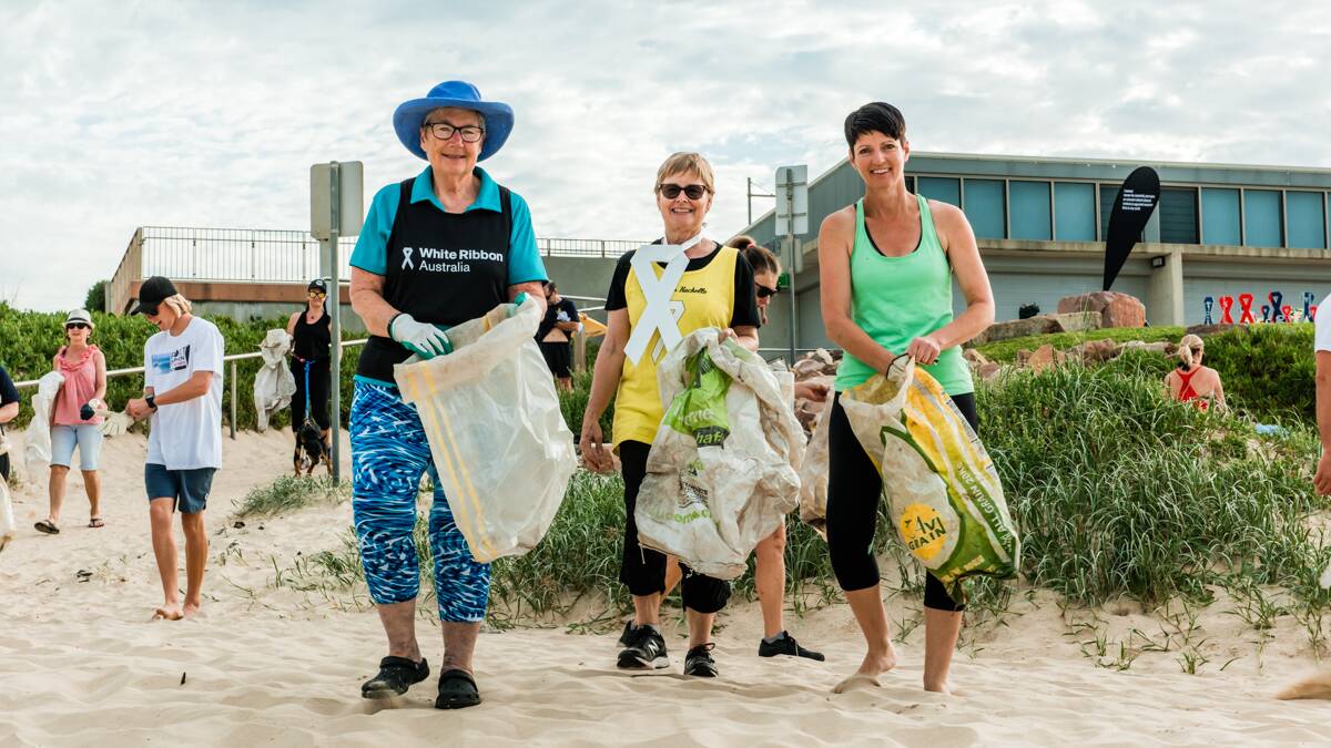 About 100 people turned out to Birubi Beach at 7am on Thursday for a White Ribbon awareness walk and clean up. 