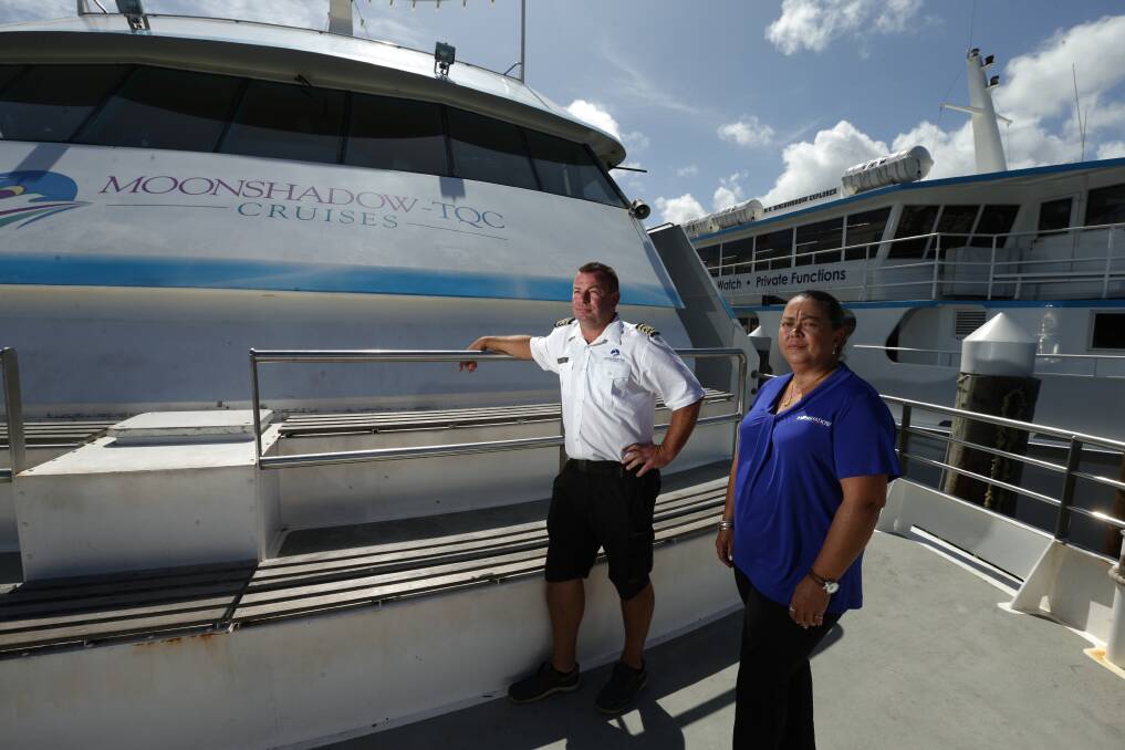 HANGING ON: Moonshadow-TQC Cruises business development manager Mel Turner with Captain Ben Lupton. Picture: Jonathan Carroll 