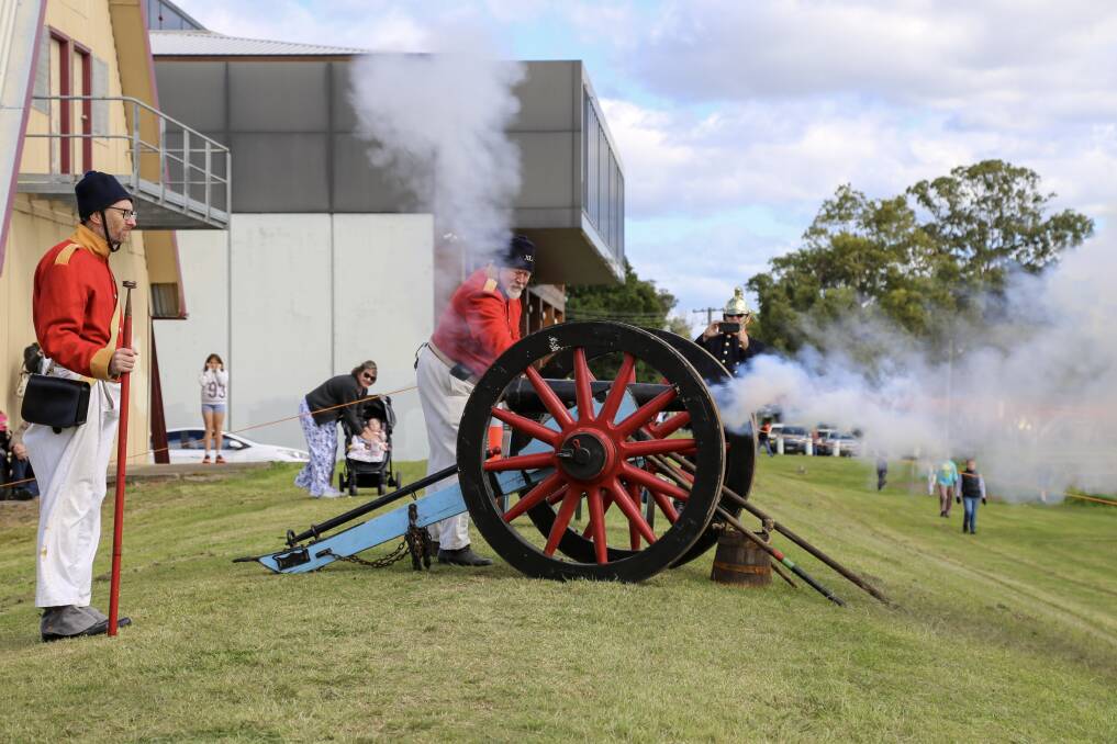 FIRE: The 40th Regiment of Foot, based in Sydney, firing a cannon on the Raymond Terrace riverfront on Saturday for the Step Back Into King Street Heritage Festival. Pictures: Ellie-Marie Watts
