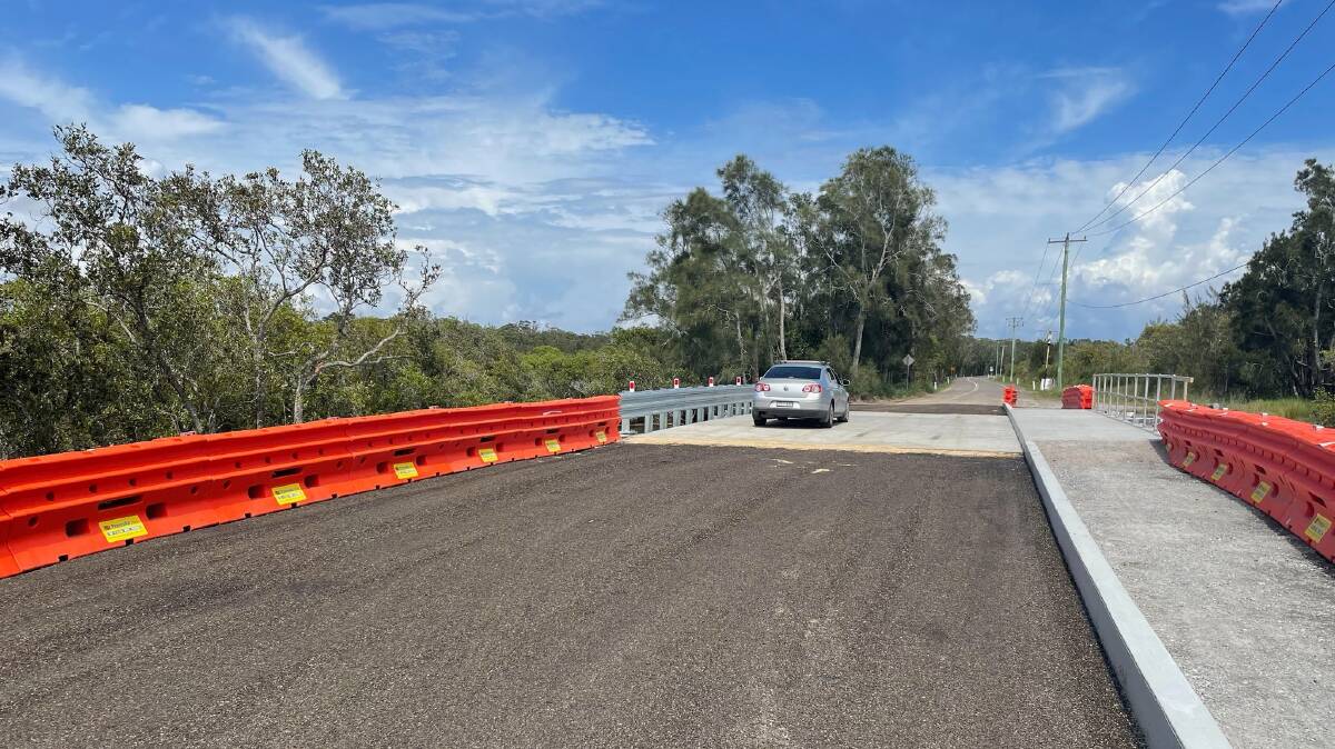 CONNECTED: Both sides of Foreshore Drive at Corlette are connected again with the bridge over the culvert that was washed away in March complete and open to traffic. Picture: Port Stephens Council