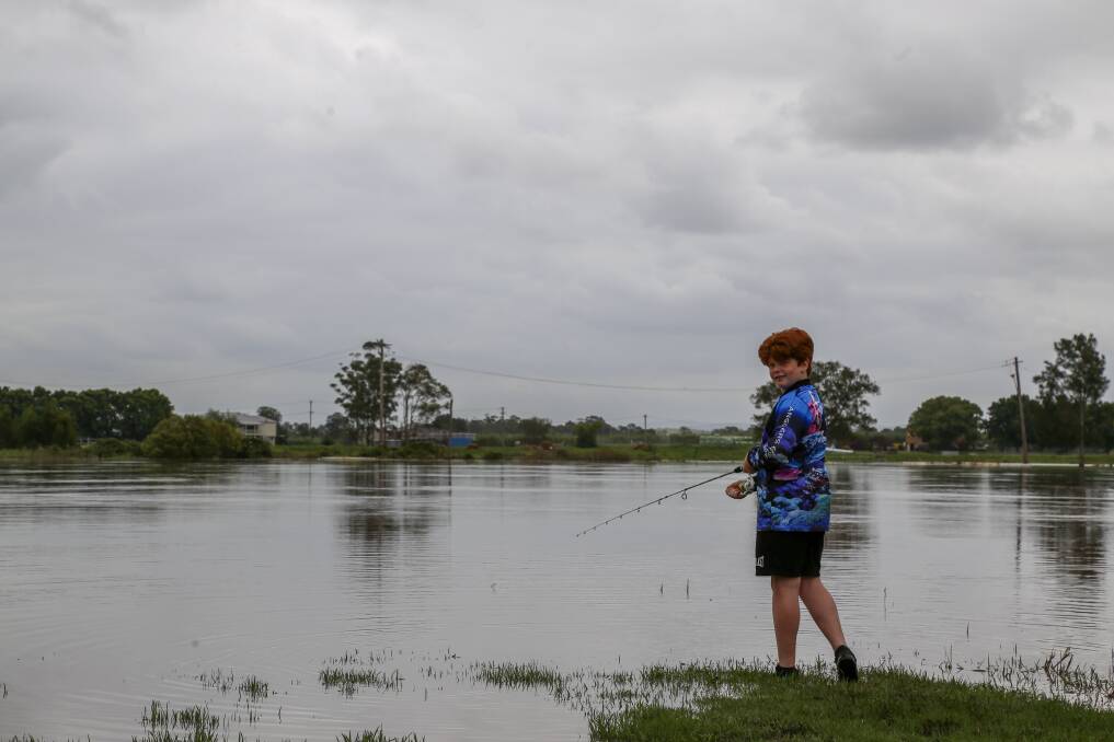 Austin Baker, 13, throws a line in the Hunter River at Raymond Terrace on Monday. His line was promptly snagged by some debris. Picture: Ellie-Marie Watts