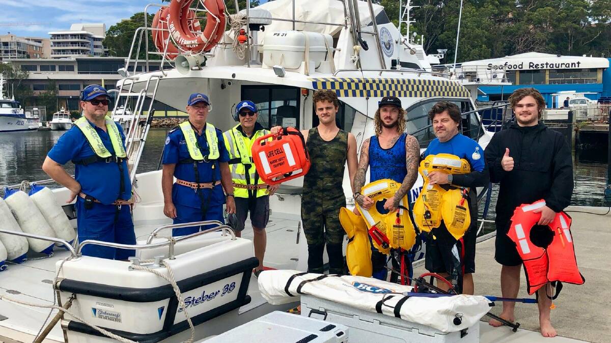 Marine Rescue Port Stephens crew with the prepared fishermen who found themselves in some trouble near Broughton Island on Monday morning. Picture: Facebook/Marine Rescue Port Stephens
