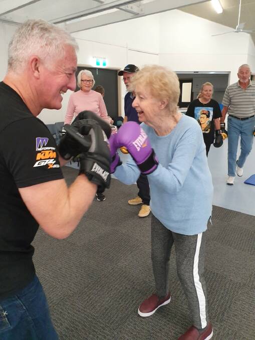 Fay Crampton, 79, having a great time exercising with her son David at one of Port Stephens Parkinson's Support Group's sessions last year.