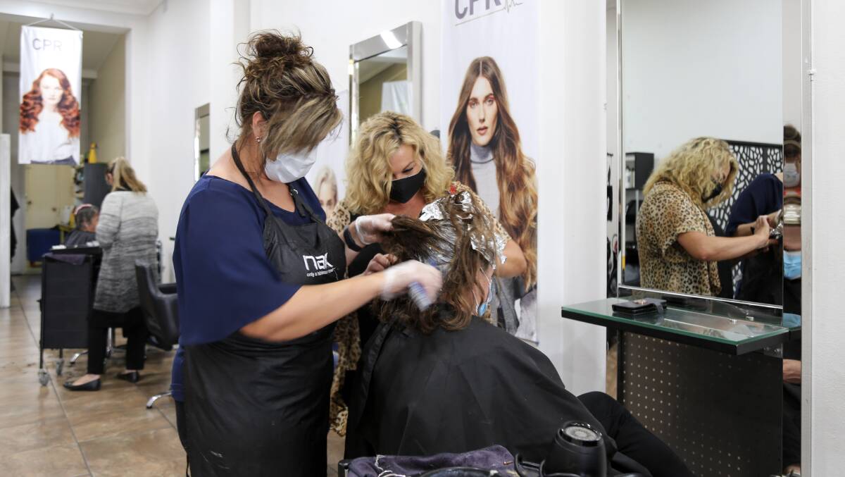 A busy Michele Petrie from Michele & Co hair salon in William Street, Raymond Terrace on Monday afternoon.