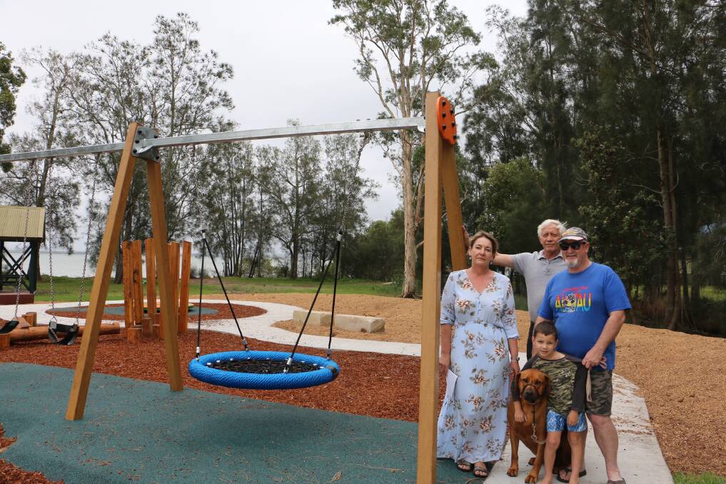 Deborah Ramage, Ralph de Ville and Garry Wanless with his grandson Blade, 5, and dog Bella at the new Caswell Reserve playground.