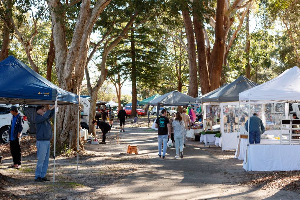 ROLL UP: Shoppers walking through the Nelson Bay Legacy Markets in winter. The markets return to Neil Carroll Park on Sunday.