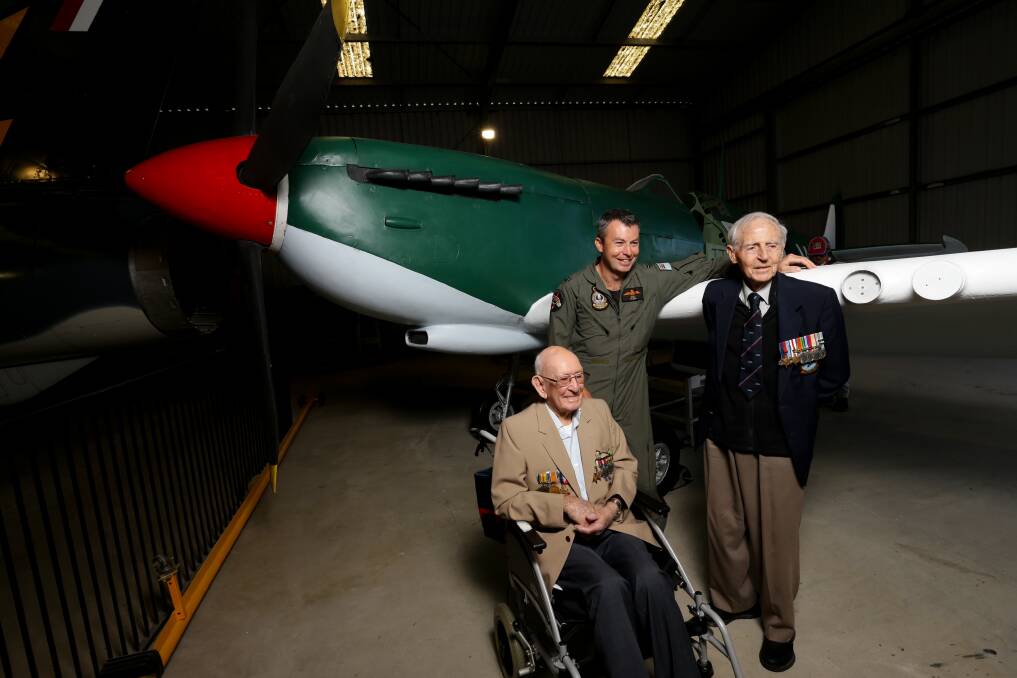 TRIBUTE: WWII Spitfire pilots Clem Jones and Sid Handsaker with Williamtown RAAF Flying Officer James Bailey in front of a replica Spitfire at Fighter World, Williamtown on Wednesday, April 21. Picture: Jonathan Carroll