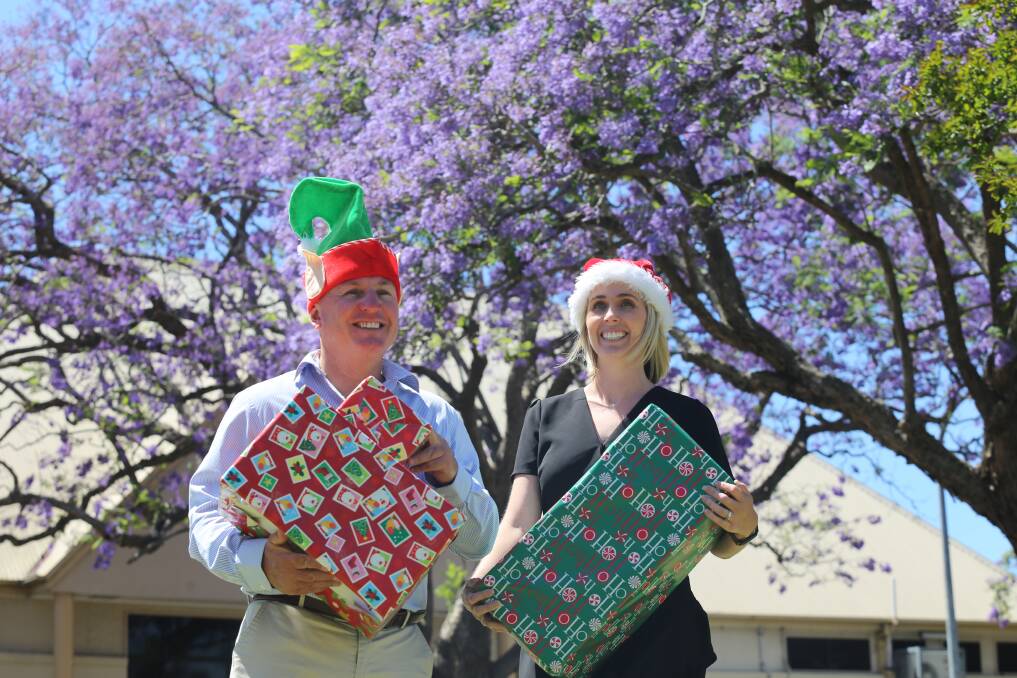 Dowling Property Raymond Terrace directors Craig Higgins and Kate Organ in Jacaranda Avenue. The Dowling Christmas toy appeal is open until Friday, December 17. Picture: Ellie-Marie Watts
