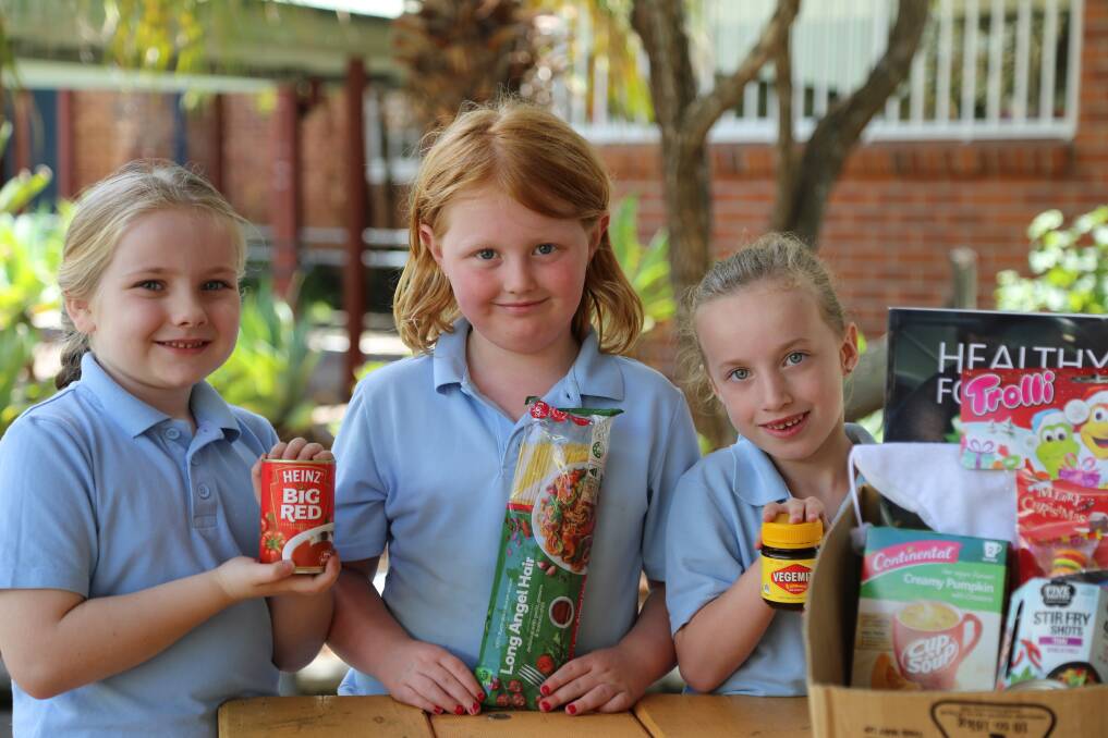 GENEROUS: Raymond Terrace Public School students Evie Smith, 6, Rhiannon Clynes, 7, and Maddie Barnes, 6, from class 1ND. Picture: Ellie-Marie Watts