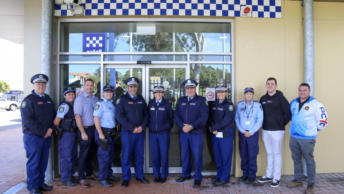 Superintendent Wayne Humphrey and Assistant Commissioner Gelina Talbot with Raymond Terrace-based police outside the station on Thursday after the Welcome Here sticker was placed on the door.