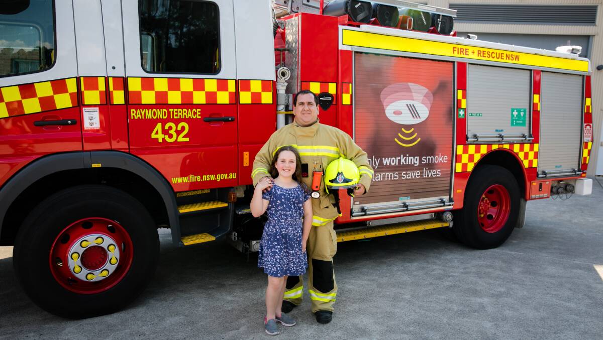 Christian Zeder a fire fighter from Raymond Terrace Fire and Rescue with daughter Bellana who will lead the parade with Irrawang High School Drum Corp.