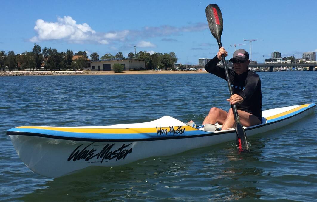 Surf skier Steve Mietzel paddling on Throsby Creek, with Newcastle Rowing Club's headquarters in the background on the Carrington shore. Picture: Scott Bevan