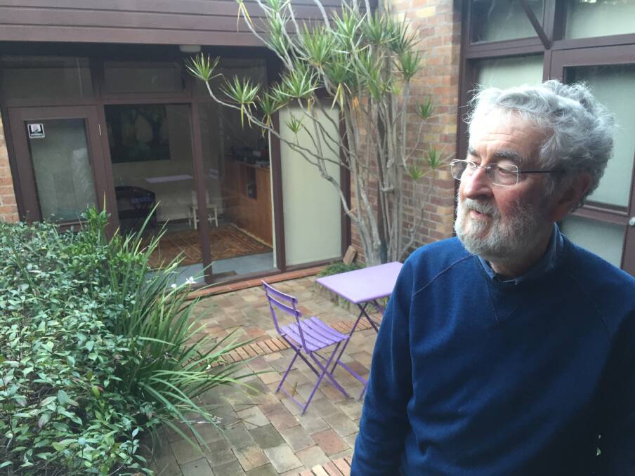 Brian Suters in the courtyard of the house he designed for the Jackson family. Picture: Scott Bevan