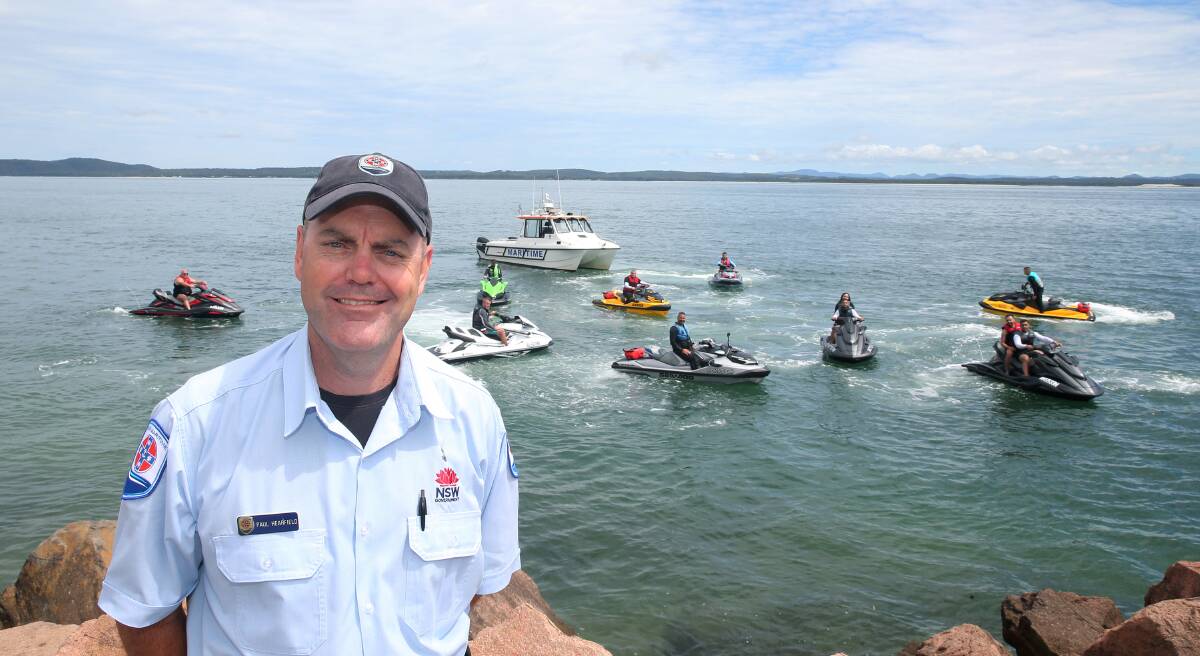 RIDE SAFE: Paul Hearfield, from Transport for NSW, with jet ski riders and a NSW Maritime boat at Nelson Bay. Picture: Peter Lorimer