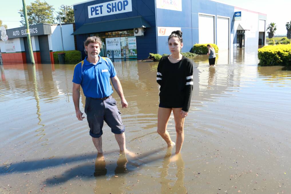ANIMALS LOST: Shane Leary and Danielle Leary in front of the flooded Pets R Us store on Port Stephens Drive, Raymond Terrace.