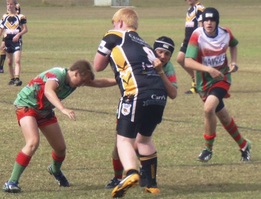 SEASON STARTING: Tea Gardens Hawks move in for the tackle.