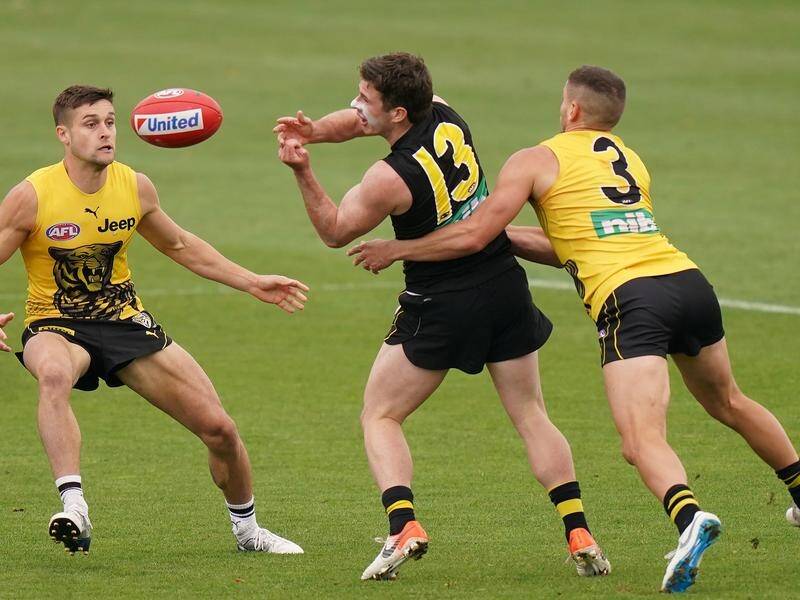 Jack Higgins (c) is back in training for Tigers and plays on Sunday after two lots of brain surgery.