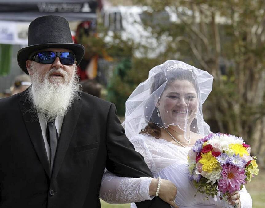SPECIAL DAY: Bride Laura Taylor walking down the street with her father. Picture: John Valentine. 