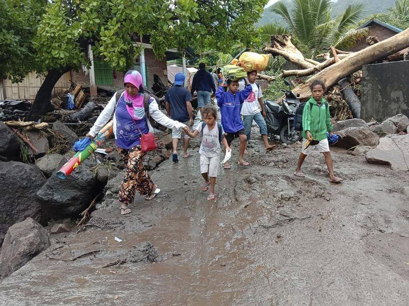 At least 86 people have been killed in landslides and flooding in Indonesia.