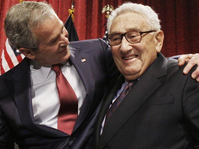 Henry Kissinger, pictured with president George W Bush in 2008, remained an influential figure. (AP PHOTO)