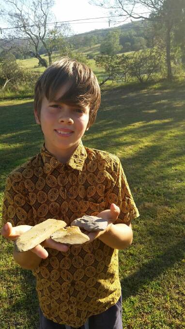 SIGNIFICANT FIND: Angelo Bruvel, 11, holds the cutting stones found at Shepherds Ground.