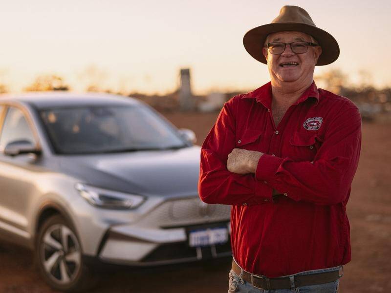 Jeffrey Johnson with his MG ZS EV electric car at his property in Mullewa, Western Australia. (HANDOUT/MG MOTOR AUSTRALIA)