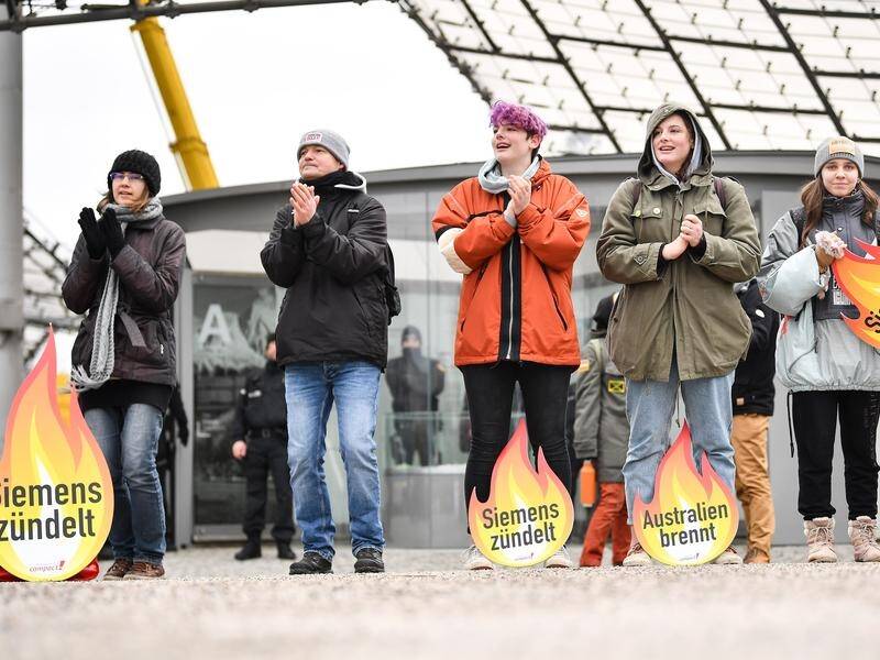 Anti-Adani activists have demonstrated outside Siemens' AGM in Germany, saying Australia is on fire.