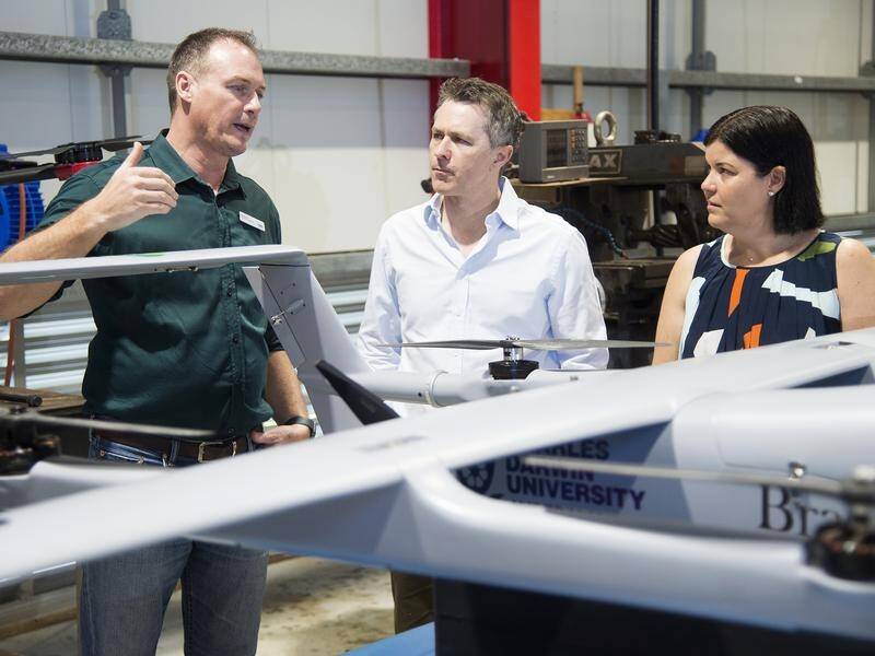 Jason Clare and Natasha Fyles inspect a drone developed at Charles Darwin University.