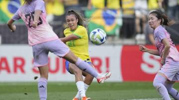 Brazil teenager Priscila (c) scores the winner against Japan in their 4-3 international win. (AP PHOTO)