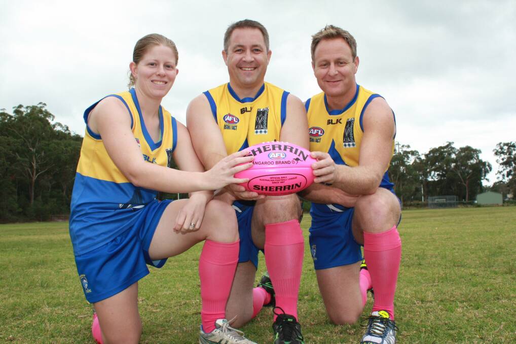 PLAYING PINK: Nelson Bay Marlins AFL players Lauren Cooper, Dominic Burge and Aaron Clayden at Dick Burwell Oval. Picture: Stephen Wark