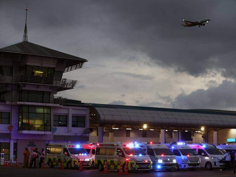 Ambulances standby to transport injured passengers from a flight from London to Singapore. (EPA PHOTO)