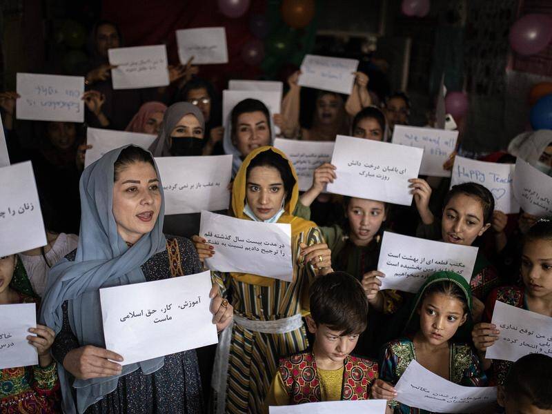 Afghan women and girls at a private school in Kabul demand their right to equal education.