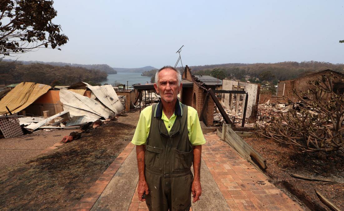 Wayne Duncombe stands in front of the remains of his beloved cottage on January 3, 2020, after fire swept through the area on New Year's Eve. Picture: Sylvia Liber