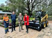 Funding representatives with the new mulcher at the Hunter Region Botanic Gardens. Photo: Supplied