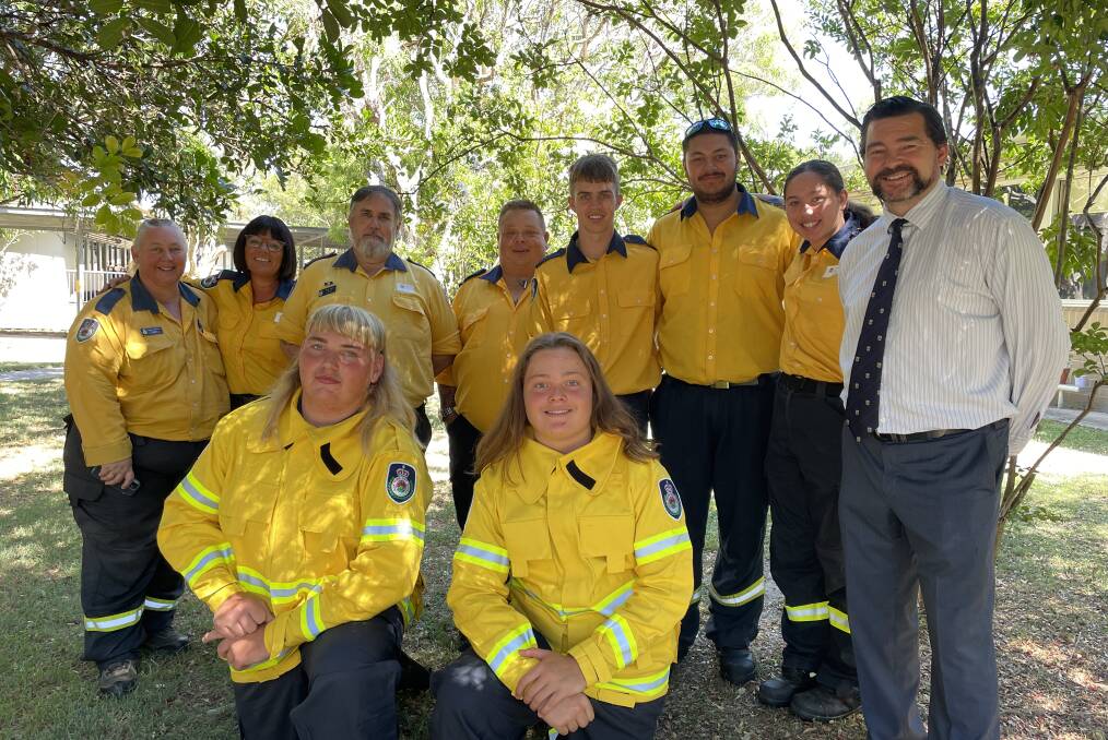 Some of the graduates with the Soldiers Point RFS crew and Tomaree High School principal Paul Baxter. 