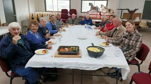 The Raymond Terrace Men's Shed and RSL sub-branch members enjoying a luncheon of the delicious food they cooked. Photo: Supplied