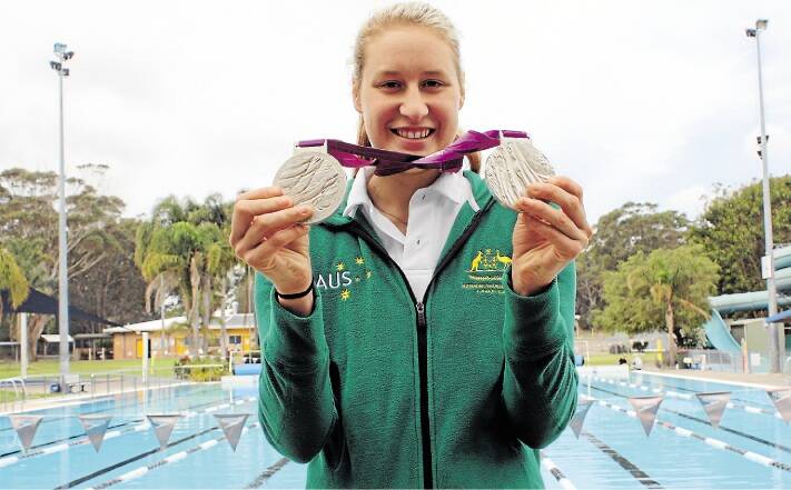 SHINING STAR: Taylor Corry with the two silver swimming medals she won at the London Paralympics. Picture: Michael McGowan